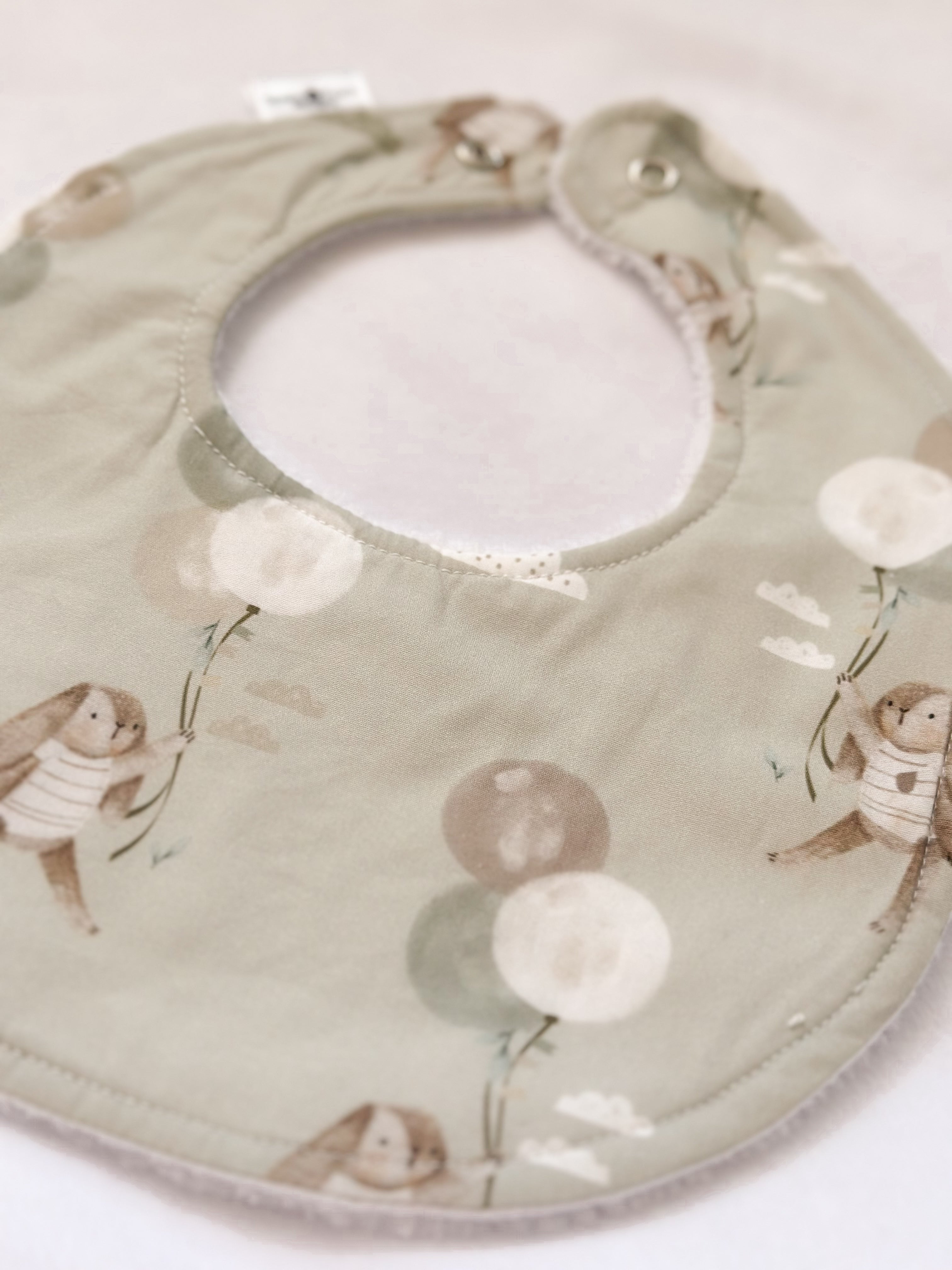 Green bunny with balloon bib