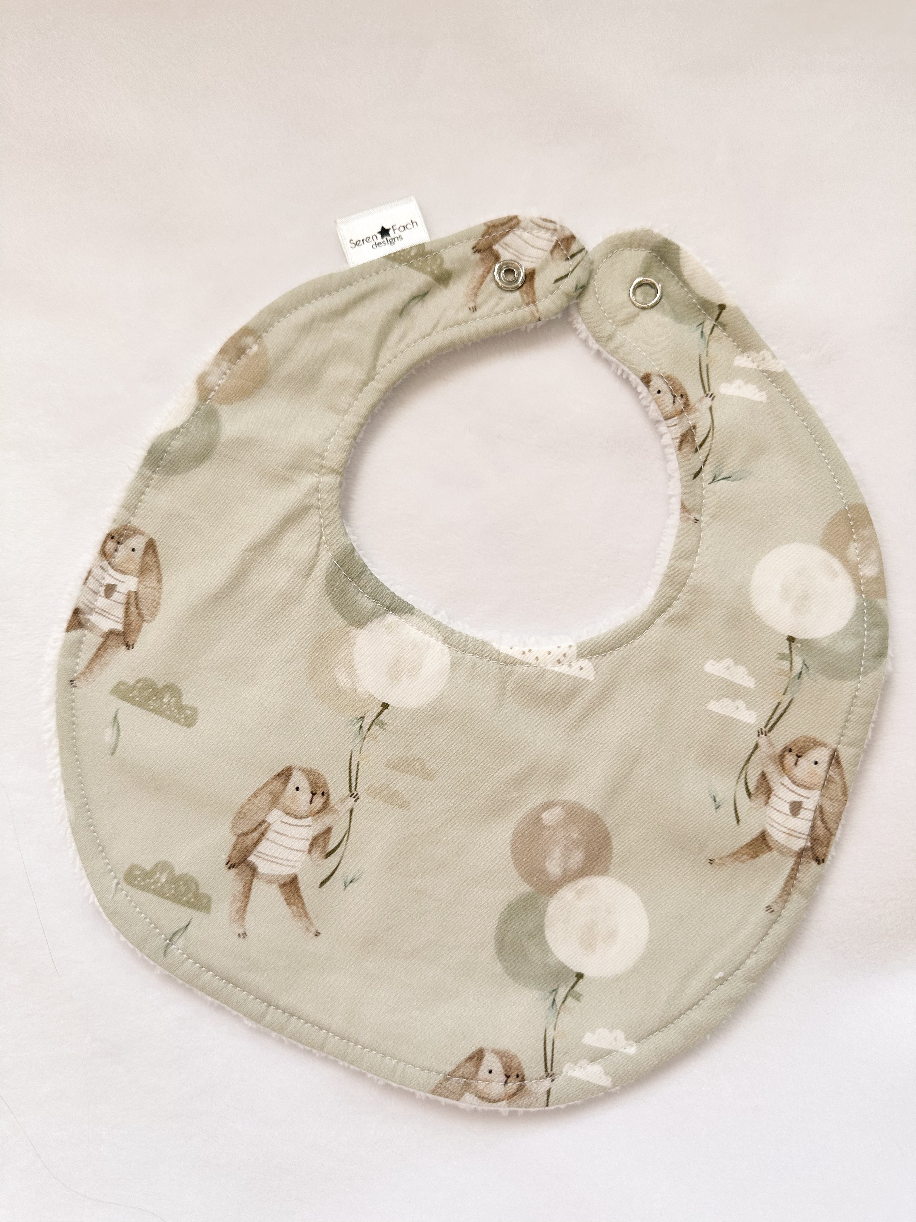 Green bunny with balloon bib